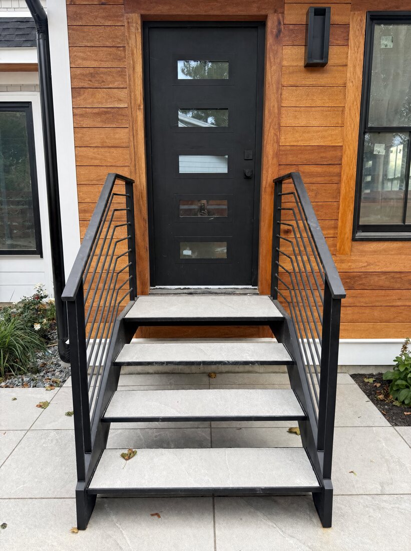 Floating exterior staircase in a satin black finish